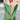 Women's green winter coat with fleece lining and white sherpa trim, featuring long sleeves and a high neck design. The coat is displayed on a mannequin or model, highlighting the outerwear's fashion-forward style and cozy textile suitable for colder weather.