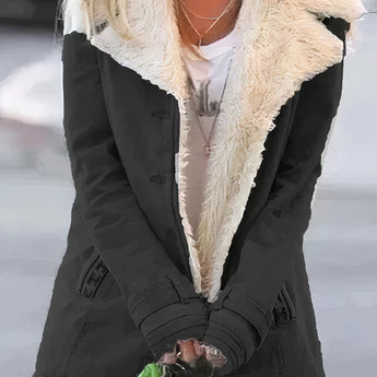 Women's green fleece-lined winter coat with sherpa trim, featuring a black and white pattern, tailored collar, and full-length sleeves.