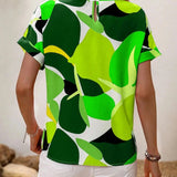 Women's short sleeve summer blouse with green leaf print, featuring a white background and a round neckline.