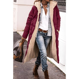 Women's green sherpa-lined insulated parka, showcasing its urban winter coat design with a cozy interior, complemented by stylish black accents, and worn over jeans.