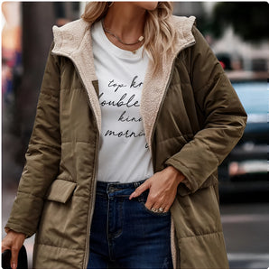 Women's green sherpa-lined insulated parka with a cozy hood, featuring a waist drawstring for a fitted silhouette, button closures, and long sleeves, perfect for urban winter wear.