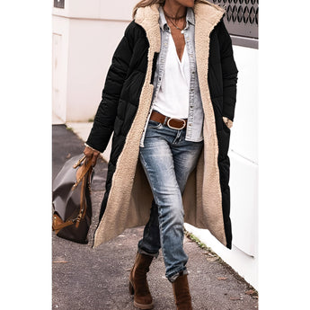 A woman wearing a black, 3XL urban winter coat with sherpa lining, styled with jeans. The parka is insulated and designed for cold weather, featuring a sleek and stylish appearance.