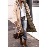 
A women's green sherpa-lined insulated parka featuring a cozy collar and full sleeves. The urban winter coat is designed to provide warmth and style, showcasing a sleek waistline.