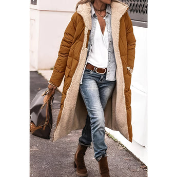 Women's green sherpa-lined insulated parka, designed for urban winter wear, featuring a stylish hood, long sleeves, and a warm, cozy interior. The model is wearing the parka with jeans and shoes, highlighting the coat's versatility and practicality for cold weather.