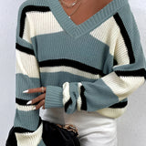 Women's green v-neck off-shoulder striped knit sweater displayed on a mannequin, showcasing details such as the shoulder, neck, and arm areas.