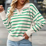 
A woman wearing a green and white striped boat neck sweater, designed for casual spring fashion, standing confidently. The sweater features long sleeves and a comfortable fit, suitable for an XL size.
