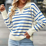 
A woman wearing a green and white striped boat neck sweater, styled for casual spring fashion. The sweater features long sleeves and a relaxed fit, paired with denim jeans.