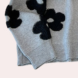 Women's grey floral sweater with a cozy crew neck design, featuring long sleeves and a knit woolen texture suitable for winter wear.