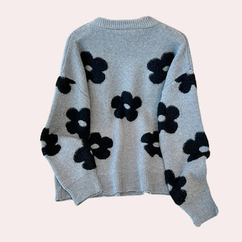 Women's grey floral sweater featuring a cozy crew neck and long sleeves, showcasing a knit pattern ideal for winter wear.