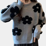 
A women's light gray floral sweater in size XL, featuring a cozy crew neck and knit fabric suitable for winter. The sweater has long sleeves and an intricate floral pattern that adds a creative touch to the design.