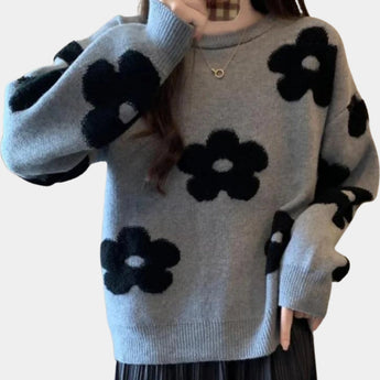 
A women's light gray floral sweater in size XL, featuring a cozy crew neck and knit fabric suitable for winter. The sweater has long sleeves and an intricate floral pattern that adds a creative touch to the design.