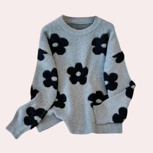 Women's grey floral sweater with a cozy crew neck design, featuring long sleeves and a subtle floral pattern, ideal for winter wear.