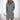 A woman wearing a grey long sleeve pullover hoodie dress in size 2XL, showcasing the cozy winter wear with a comfortable fit around the neck, waist, and elbows.