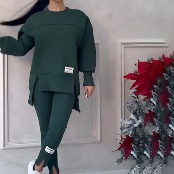 Women's grey loungewear set featuring a stylish and comfortable sweatshirt with long sleeves and matching pants. The outfit is designed for a relaxed fit, suitable for casual wear.