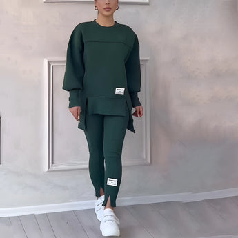Women's grey loungewear set featuring a comfortable sweatshirt with sleeves and pants, shown on a model in a relaxed pose. The variant displayed is in a green color and size 3XL.