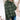 Women's grey plaid fleece sweater with high neck pullover design, featuring a tartan pattern. The sweater is styled with long sleeves and appears to be paired with jeans.