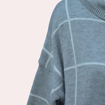 Women's grey plaid fleece sweater with high neck pullover design, featuring long sleeves and a cozy, patterned fabric.