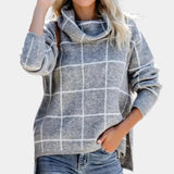 Women's grey plaid fleece sweater with a cozy high neck, featuring long sleeves and a soft textile texture.