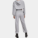 Women's grey tracksuit set featuring a cropped hoodie and joggers, showcasing an urban athleisure style with long sleeves and a comfortable waist fit.