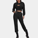 Women's grey tracksuit set featuring a cropped hoodie and joggers, displayed in a black, size XL variant. The set is designed for urban athleisure wear, highlighting the casual and stylish fit, with attention to detailing around the neck, sleeves, and waist.