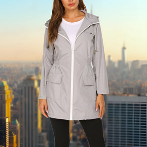 Women's grey waterproof hooded raincoat, featuring a lightweight and urban style design with a standing collar and long sleeves.