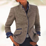 Women's grey wool blazer with blue trim, featuring a chic designer style, a collar, and long sleeves.