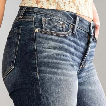 Women's high-waist dark wash flared stretch jeans displayed on a model, showcasing the denim fabric and flared leg style.