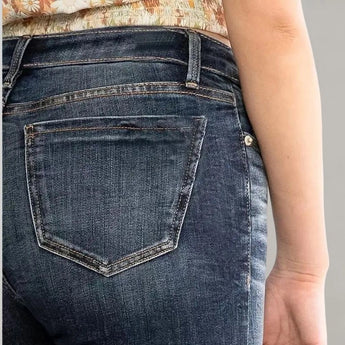 Women's high-waist dark wash flared stretch jeans displayed on a mannequin showing the denim fabric and flare leg design.