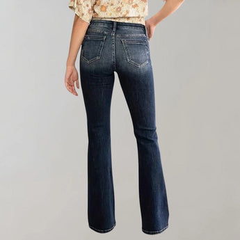 Women's high-waist dark wash flared stretch jeans displayed against a neutral background, showcasing the waist and thigh areas.