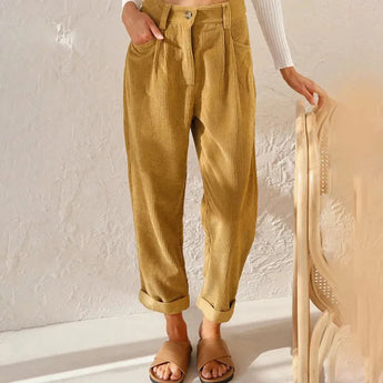 Women's high-waisted terracotta corduroy cropped pants in khaki color, shown on a model, emphasizing the fit around the waist, thighs, and knees.