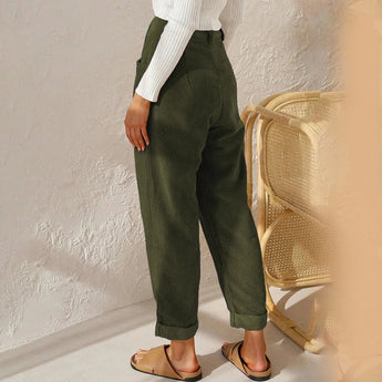 High-waisted terracotta corduroy cropped pants for women shown on a model, highlighting the waist and thigh areas.