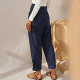 Women's high-waisted terracotta corduroy cropped pants with a textured fabric, shown paired with a light dress shirt and sandals.