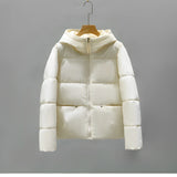 Women's hooded color block insulated puffer jacket with long sleeves and a stylish design, featuring a high collar for added warmth and protection against the cold.
