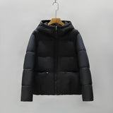 Women's black and grey color block insulated puffer jacket with a hood, featuring long sleeves, a collar, and multiple pockets; shown in size 2XL.