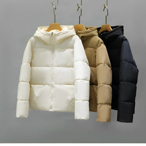 Women's hooded color block puffer jacket with insulated material, features long sleeves and a stylish, symmetrical color block pattern.