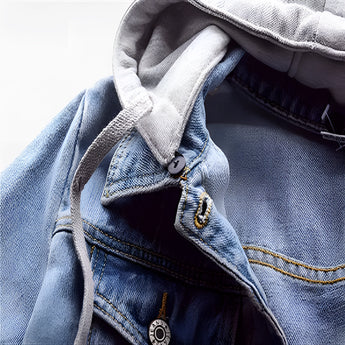 Women's light wash denim jacket with a fleece lining, featuring a hood and long sleeves, shown in a close-up view highlighting the fabric texture and design details.