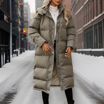 Women's insulated taupe hooded puffer coat featuring a long design, with a plush fur-trimmed hood and full-length sleeves, ideal for winter weather.
