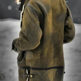 A woman wearing an insulated winter parka with a faux fur hood, featuring a waterproof design, and standing outdoors. She is dressed warmly, with gloves on her hands, highlighting the parka's long sleeves and overall protective coverage.