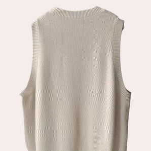 Sleeveless ivory cable knit sweater vest with a ribbed mock neck design.
