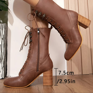 Women's brown leather ankle boots with a 7.5cm heel, featuring a lace-up design and fashion-forward style.