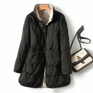 Stylish women's lightweight black hooded puff jacket with long sleeves and a water-resistant finish, designed for a sleek and fashionable look.