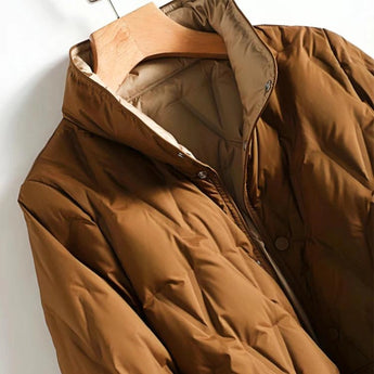 Women's lightweight black hooded puff jacket with water-resistant material, featuring a stylish design with long sleeves and a high collar.