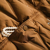 
A women's lightweight black hooded puff jacket, designed with a water-resistant material and stylish cut, showcasing long sleeves and a fitted waist.