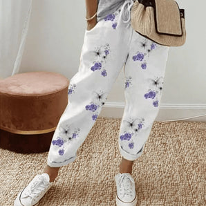 
A pair of women's lilac floral joggers in a lightweight and relaxed fit, displayed in size 3XL. The joggers feature a soft purple hue with a floral pattern, designed for comfort and style.
