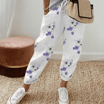 
A pair of women's lilac floral joggers in a lightweight and relaxed fit, displayed in size 3XL. The joggers feature a soft purple hue with a floral pattern, designed for comfort and style.