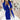 Women's long blue double-breasted blazer in a tailored office chic style, featuring structured shoulders, a defined waist, and long sleeves.