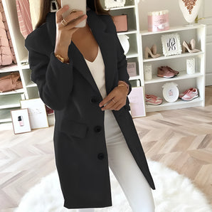 
A woman wearing a women's long black double-breasted blazer, tailored for an office chic look, in size 4XL. The blazer features classic fashion design elements like a structured collar, long sleeves, and a defined waist, giving it a sophisticated and polished appearance.