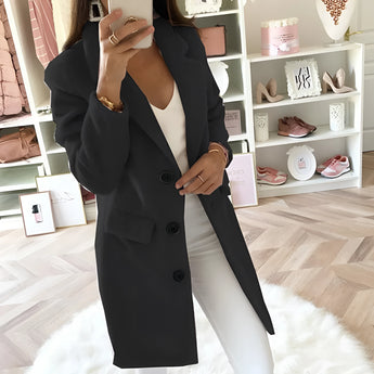 
A woman wearing a women's long black double-breasted blazer, tailored for an office chic look, in size 4XL. The blazer features classic fashion design elements like a structured collar, long sleeves, and a defined waist, giving it a sophisticated and polished appearance.