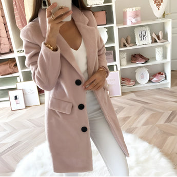 Long black double-breasted blazer for women with tailored fit, featuring a rose color accent, suitable for office wear.
