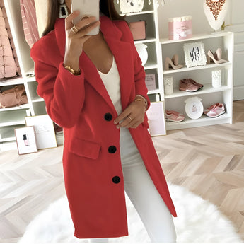 Women's long black oversized blazer, featuring a tailored chic design. The blazer includes a structured collar, long sleeves, and a relaxed fit, conveying an elegant and fashion-forward appearance.